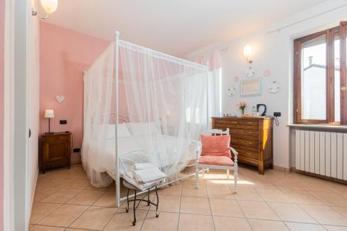 a bedroom with a bed and a desk and a chair at B&B Lanterna delle Fate in Asti