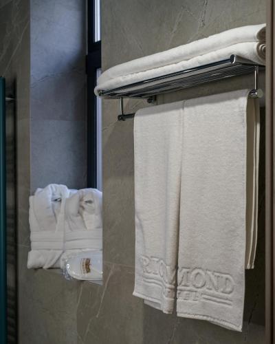 a bathroom with white towels on a towel rack at Richmond Hotel in Chişinău