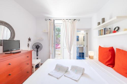 a bedroom with a white bed with two white towels at BeGuest Cascais Casa da Tia Marta in Cascais