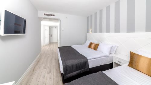 Кровать или кровати в номере Motto Premium Hotel&Spa