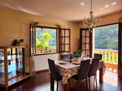 a dining room with a table and chairs at Gomes house in Ponta do Sol