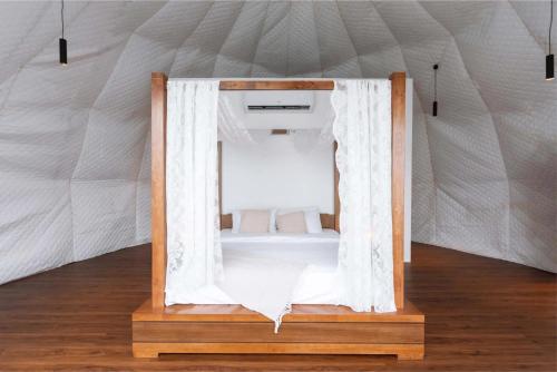 a mirror in a bed in a tent at Serene Glamping سيرين in Salalah