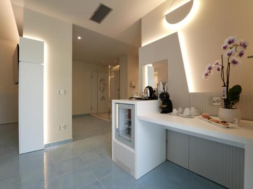 a kitchen with a counter and a counter top at Hotel Village Eden in Capo Vaticano