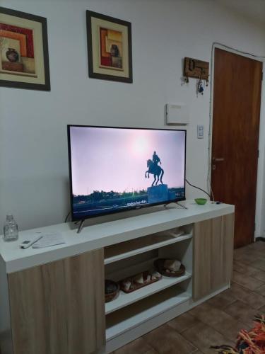 a flat screen tv sitting on top of a cabinet at Departamento Nueva Córdoba in Cordoba