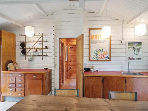 a kitchen with a wooden table and a counter at 5 person holiday home in Vejby-By Traum in Vejby