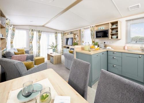 a kitchen and living room of a caravan at Parc Farm Holiday Park in Mold
