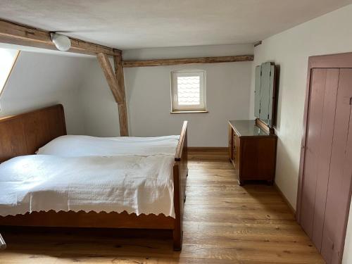 a bedroom with a bed and a dresser and a window at Am Schusterberg in Schielo