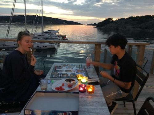 a woman and a boy sitting at a table eating food at Marinan Richters in Fjällbacka