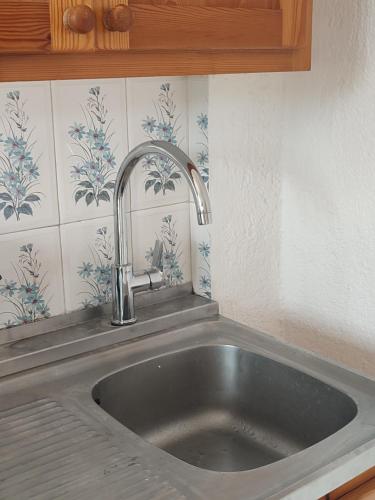 a kitchen sink with a faucet in a kitchen at Marianna Apartments in Agia Pelagia