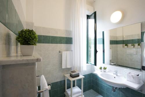 a bathroom with a sink and a mirror at Hotel Angiolino in Chianciano Terme