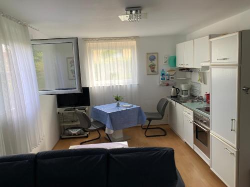 a small kitchen with a blue table in a room at Haus Idylle Weindorf Duchroth - Helle Souterrain Ferienwohnung in Duchroth