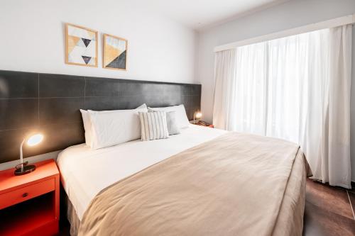 a bedroom with a large bed and a window at 5411 Soho Hotel in Buenos Aires