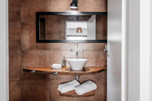 a bathroom with a sink and a mirror at 5411 Soho Hotel in Buenos Aires