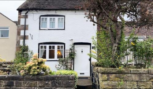 a white house with a white door at Chapter Cottage, Cheddleton Nr Alton Towers, Peak District, Foxtail Barns, the Ashes in Cheddleton