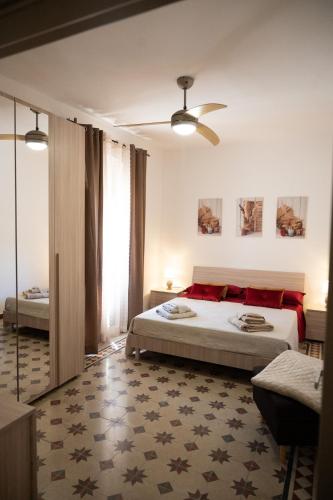 a bedroom with two beds and a large window at Giulietta Normanna in Sciacca