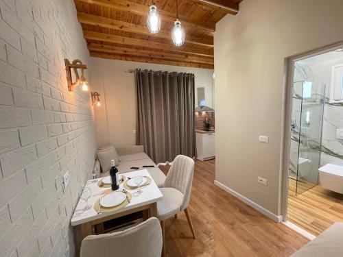 a dining room with a table and chairs in a room at Arial Penthouse Suites in Vlorë