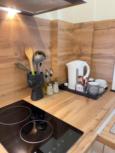 a kitchen with a counter top with a stove top oven at Arial Penthouse Suites in Vlorë