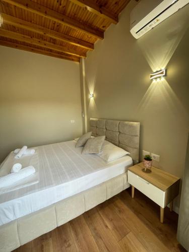 a bedroom with a large bed and a table at Arial Penthouse Suites in Vlorë