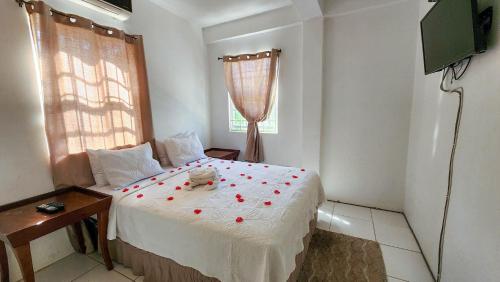 a bedroom with a bed with red rose petals on it at Caribbean Dream Vacation Property CD2 in Rodney Bay Village