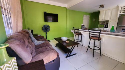 a living room with a couch and a kitchen at Caribbean Dream Vacation Property CD2 in Rodney Bay Village