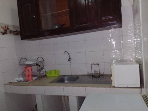 a kitchen with a sink and a counter top at Rincon d'Alicia in Dakar