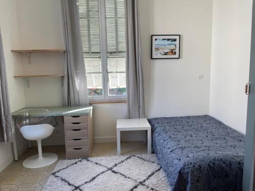 une chambre avec un lit, un bureau et une fenêtre dans l'établissement appartement nice, à Nice