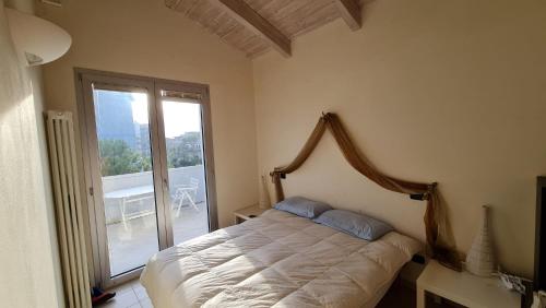 ein Schlafzimmer mit einem Bett und einem großen Fenster in der Unterkunft Residence La Settima in Milano Marittima