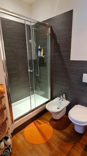 a bathroom with a shower and a toilet and a sink at Residence La Settima in Milano Marittima