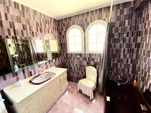 a bathroom with a sink and a mirror and a shower at Villa Daurus in Vallauris