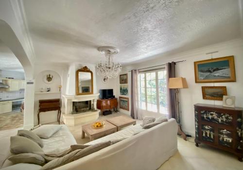 a living room with a couch and a fireplace at Villa Daurus in Vallauris