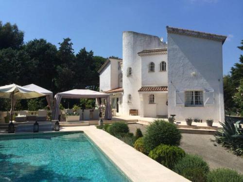 a house with a swimming pool in front of it at Villa Daurus in Vallauris