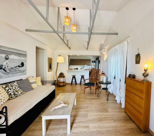 a living room with a couch and a table at Anastasias Cottage in Nea Irakleia