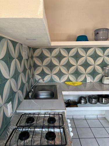 a kitchen with a sink and a counter top at MonteMar Hotel y Bungalows in Rincon de Guayabitos