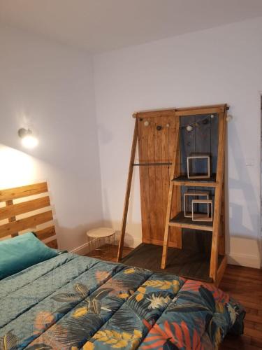 - une chambre avec un lit et un four micro-ondes sur une étagère dans l'établissement Gîte Stevalou, à Labarthe-Rivière