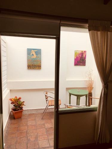 a room with a door and a table at Hotel Posada de San Agustin in Tunja