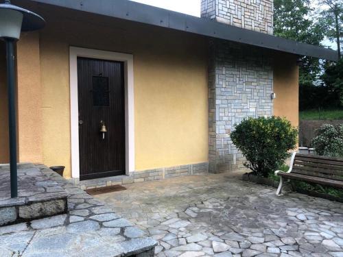 una casa con una puerta marrón y un banco en Villa Roberta en Fiano