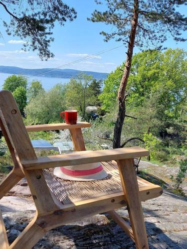 a wooden picnic table with a cup on top of it at fjord : oslo in Nordstrand