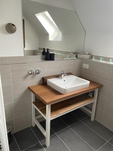 a bathroom with a sink and a mirror at Dieckmann's Hotel in Dortmund