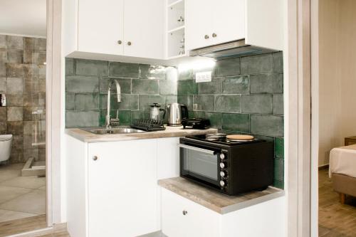 a small kitchen with a stove and a sink at Sia's Sea House in Almyrida