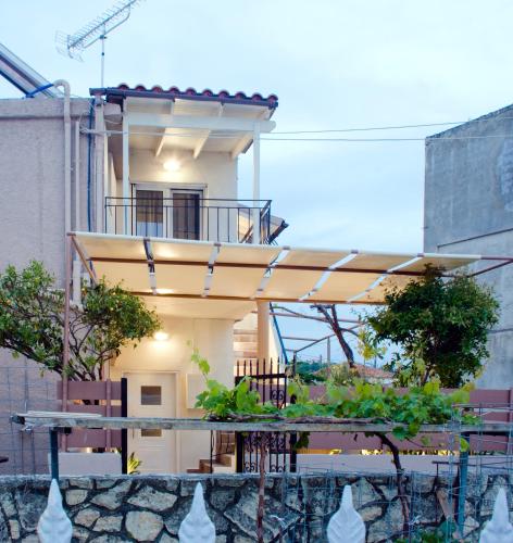 a house with a table in front of it at Sia's Sea House in Almirida