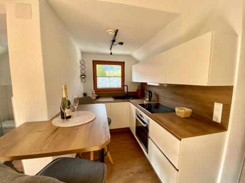 a kitchen with a table with a bottle of wine at Studio Rittisberg im Haus Sonnleitner in Ramsau am Dachstein