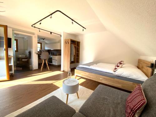 a living room with a bed and a couch at Studio Rittisberg im Haus Sonnleitner in Ramsau am Dachstein