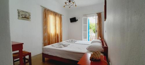 a small bedroom with a bed and a window at Fragos Apartments in Santa Maria