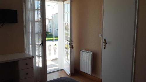 a hallway with an open door to a balcony at Maison avec Jardin privé in Saint-Hilaire-de-Riez