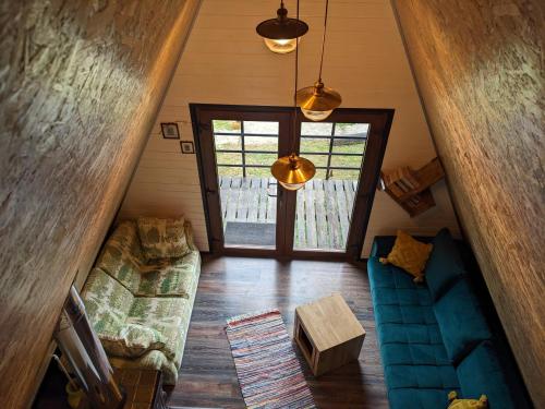 an overhead view of a living room with a couch at Open View Place The A Frame in Scăricica