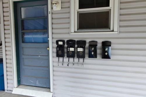 a group of knives hanging on a wall next to a door at Spacious Suite Close to Downtown Indy/ King Bed in Indianapolis