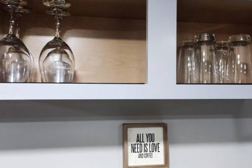 a sign that says all you need to buy is wine glasses at Spacious Suite Close to Downtown Indy/ King Bed in Indianapolis