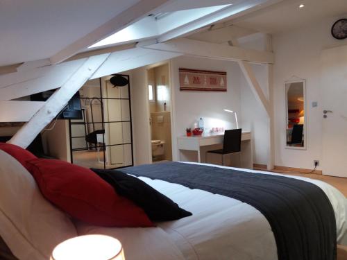 een slaapkamer met een groot bed en een bureau bij Chambres d'Hôtes LA PASTOURELLE Royan centre in Royan