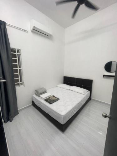 a bedroom with a bed in a white room at Ayra De Villa -Ayra Homestay 9-bedroom with Private Pool in Shah Alam