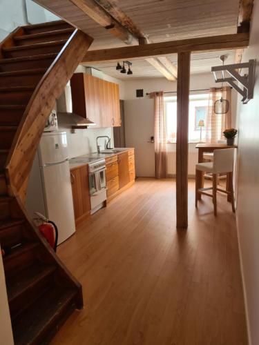 a kitchen with a staircase leading to a dining room at Lgh centralt i Ystad in Ystad